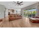Open-concept living space with hardwood floors, a comfortable sofa, and sliding doors to the outdoor area at 4213 Hickory Oaks St, Castle Rock, CO 80104