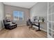 Home office with hardwood floors, a large window, comfortable leather chair, and a modern adjustable desk at 4213 Hickory Oaks St, Castle Rock, CO 80104