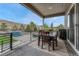 Inviting covered patio with a dining table and chairs, offering scenic views of the green landscape at 4213 Hickory Oaks St, Castle Rock, CO 80104