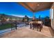 Inviting covered patio with dining table offering a scenic view of the green grass and landscaping at 4213 Hickory Oaks St, Castle Rock, CO 80104