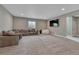Spacious, carpeted recreation room with a large sectional, a TV, and a beanbag chair for versatile Gathering enjoyment at 4213 Hickory Oaks St, Castle Rock, CO 80104