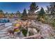 Relaxing backyard water feature surrounded by lush landscaping and stone accents at 4213 Hickory Oaks St, Castle Rock, CO 80104
