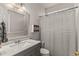 Charming bathroom featuring a gray vanity with a white countertop and decorative mirror accent at 6614 W Gould Dr, Littleton, CO 80123