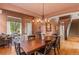 Open dining and living spaces featuring hardwood floors, natural light, and easy access to the staircase at 6614 W Gould Dr, Littleton, CO 80123