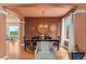 Formal dining room with hardwood floors, elegant lighting, and views into the adjacent living areas at 6614 W Gould Dr, Littleton, CO 80123
