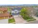 Traditional two-story home featuring a large driveway and well-maintained lawn and landscaping at 6614 W Gould Dr, Littleton, CO 80123