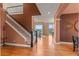 Inviting foyer with hardwood floors, an elegant staircase, and views of the living room and outdoor patio at 6614 W Gould Dr, Littleton, CO 80123