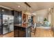 Modern kitchen featuring dark cabinetry, stainless appliances, and a large center island at 6614 W Gould Dr, Littleton, CO 80123