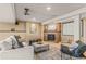 Comfortable living room features a brick fireplace, a projector, and neutral decor at 6614 W Gould Dr, Littleton, CO 80123