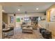 Open-concept living room boasts a wet bar, comfortable seating, and great lighting at 6614 W Gould Dr, Littleton, CO 80123