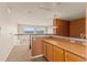Bright living room features large windows with mountain views and a small kitchenette at 6614 W Gould Dr, Littleton, CO 80123
