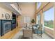 Bright living room featuring hardwood floors, a fireplace, and views of the home's second level at 6614 W Gould Dr, Littleton, CO 80123