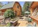 Backyard with water feature, outdoor seating, fire pit, and wooded landscape creates a relaxing retreat at 12191 Tecumseh Trl, Conifer, CO 80433