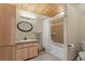 Bathroom featuring a shower and tub combo, wood trim and lighting, and a wood vanity at 12191 Tecumseh Trl, Conifer, CO 80433