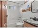 Bright bathroom with a window above the tub, white tile, and classic fixtures at 12191 Tecumseh Trl, Conifer, CO 80433