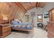 Bedroom with wood ceiling and trim, featuring natural light and wood furniture at 12191 Tecumseh Trl, Conifer, CO 80433