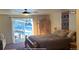 Bedroom featuring a sliding glass door, wood bedframe, and decorative wall hanging at 12191 Tecumseh Trl, Conifer, CO 80433