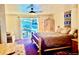 Bright bedroom with sliding glass doors, log bed frame, and scenic outdoor views at 12191 Tecumseh Trl, Conifer, CO 80433