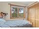 Comfortable bedroom featuring a large window and closet at 12191 Tecumseh Trl, Conifer, CO 80433