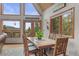 Bright dining room with large windows offering picturesque views of surrounding nature at 12191 Tecumseh Trl, Conifer, CO 80433