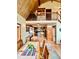 Open-concept dining area with a wooden table, exposed beams, wood trim and access to the kitchen area at 12191 Tecumseh Trl, Conifer, CO 80433