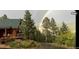 Cozy home with wood siding, green roof, deck and rainbow in the distance at 12191 Tecumseh Trl, Conifer, CO 80433