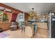 Charming kitchen featuring a granite island, stainless steel appliances, and abundant natural light at 12191 Tecumseh Trl, Conifer, CO 80433