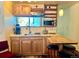 Well-lit kitchen with stainless steel appliances, custom cabinets and bar seating at 12191 Tecumseh Trl, Conifer, CO 80433
