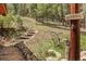 Landscaped property features rock stairs and trail, surrounded by lush greenery and trees at 12191 Tecumseh Trl, Conifer, CO 80433