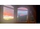 Breathtaking sunset view through arched windows overlooking scenic mountains at 12191 Tecumseh Trl, Conifer, CO 80433