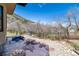 Beautiful backyard with stone steps, patio seating, and a hot tub against a mountain backdrop at 5668 Red Fern Ct, Littleton, CO 80125