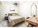 Minimalist bedroom with a warm-toned bed, modern lighting, and a functional desk space at 5668 Red Fern Ct, Littleton, CO 80125