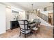 Elegant dining room featuring a black table, decorative chandelier, and stylish chairs at 5668 Red Fern Ct, Littleton, CO 80125