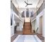 Grand foyer with a split staircase, high ceilings, and views of the mountains at 5668 Red Fern Ct, Littleton, CO 80125
