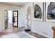 Hallway with unique art and open doorway offering a glimpse into the next room at 5668 Red Fern Ct, Littleton, CO 80125