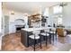 Modern kitchen with a center island, white cabinetry, and stainless steel appliances offers a sleek design at 5668 Red Fern Ct, Littleton, CO 80125