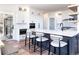 Beautiful kitchen with white cabinets, center island and bar stools at 5668 Red Fern Ct, Littleton, CO 80125