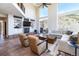 Spacious living room boasts a fireplace, built-in shelving and cabinetry, and abundant natural light at 5668 Red Fern Ct, Littleton, CO 80125