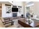 Cozy living room with a fireplace, built-in shelves, and a sliding door at 5668 Red Fern Ct, Littleton, CO 80125