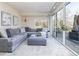 Cozy living room with a comfortable gray sectional sofa and sliding glass doors to the outside at 5668 Red Fern Ct, Littleton, CO 80125
