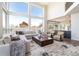 Open-concept living room with a large sectional couch, comfortable chairs, and views of the surrounding landscape at 5668 Red Fern Ct, Littleton, CO 80125