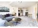 Modern living space with a gray sofa, dining area, and kitchenette for convenient, stylish living at 5668 Red Fern Ct, Littleton, CO 80125