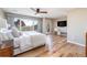 Main bedroom features natural light, wood floors, TV, outdoor access, and mountain views at 5668 Red Fern Ct, Littleton, CO 80125