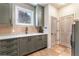 Mudroom features earth tone cabinets, counter space with sink, large window, and access to the garage at 5668 Red Fern Ct, Littleton, CO 80125