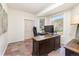 Bright home office with hardwood floors, mountain views, and a large desk at 5668 Red Fern Ct, Littleton, CO 80125