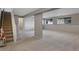 Spacious finished basement with carpet, neutral walls, and natural light at 86 Woodland Cir, Highlands Ranch, CO 80126