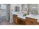 Bathroom featuring dual sinks, a vanity area, and a glass shower at 86 Woodland Cir, Highlands Ranch, CO 80126