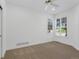 Bright bedroom features neutral carpet, white walls, a ceiling fan, and shuttered windows at 86 Woodland Cir, Highlands Ranch, CO 80126