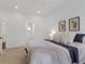 Calm bedroom with neutral bedding and framed artwork at 86 Woodland Cir, Highlands Ranch, CO 80126