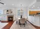 Elegant dining area featuring a cozy fireplace, natural lighting, and hardwood floors, perfect for Gathering meals at 86 Woodland Cir, Highlands Ranch, CO 80126